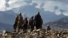 Afghanistan -- Anti-Taliban Afghan fighters watch several explosions from U.S. bombings